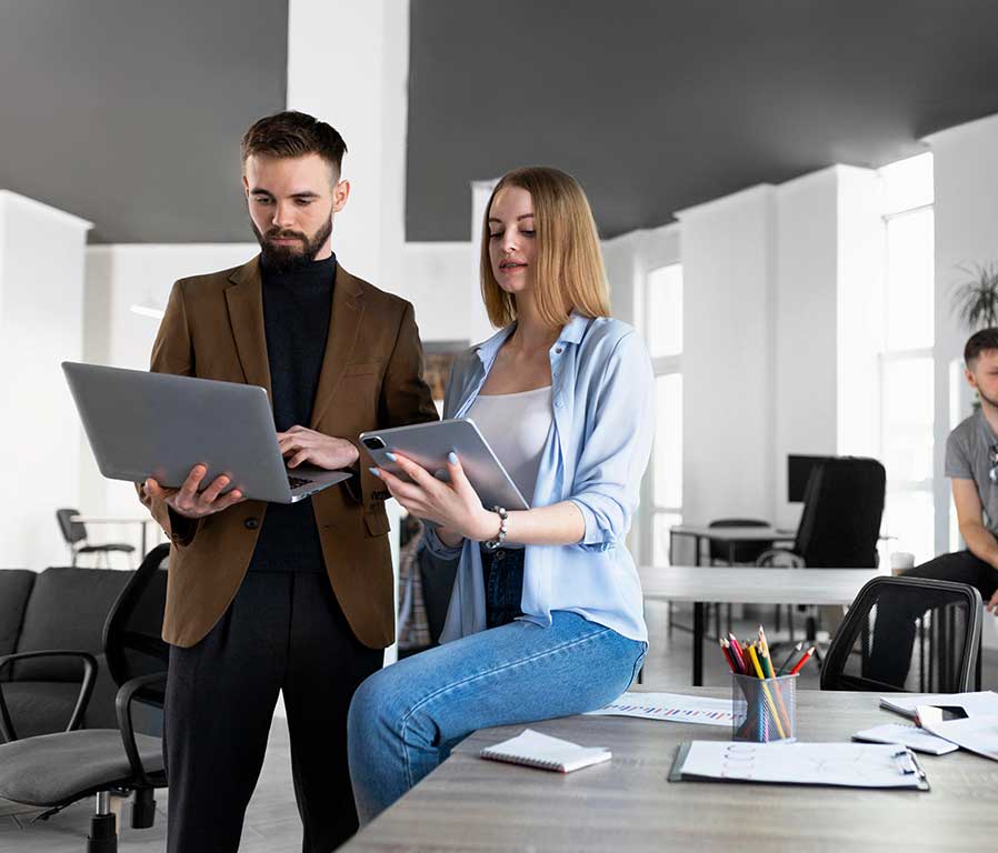 a man standing with a laptop